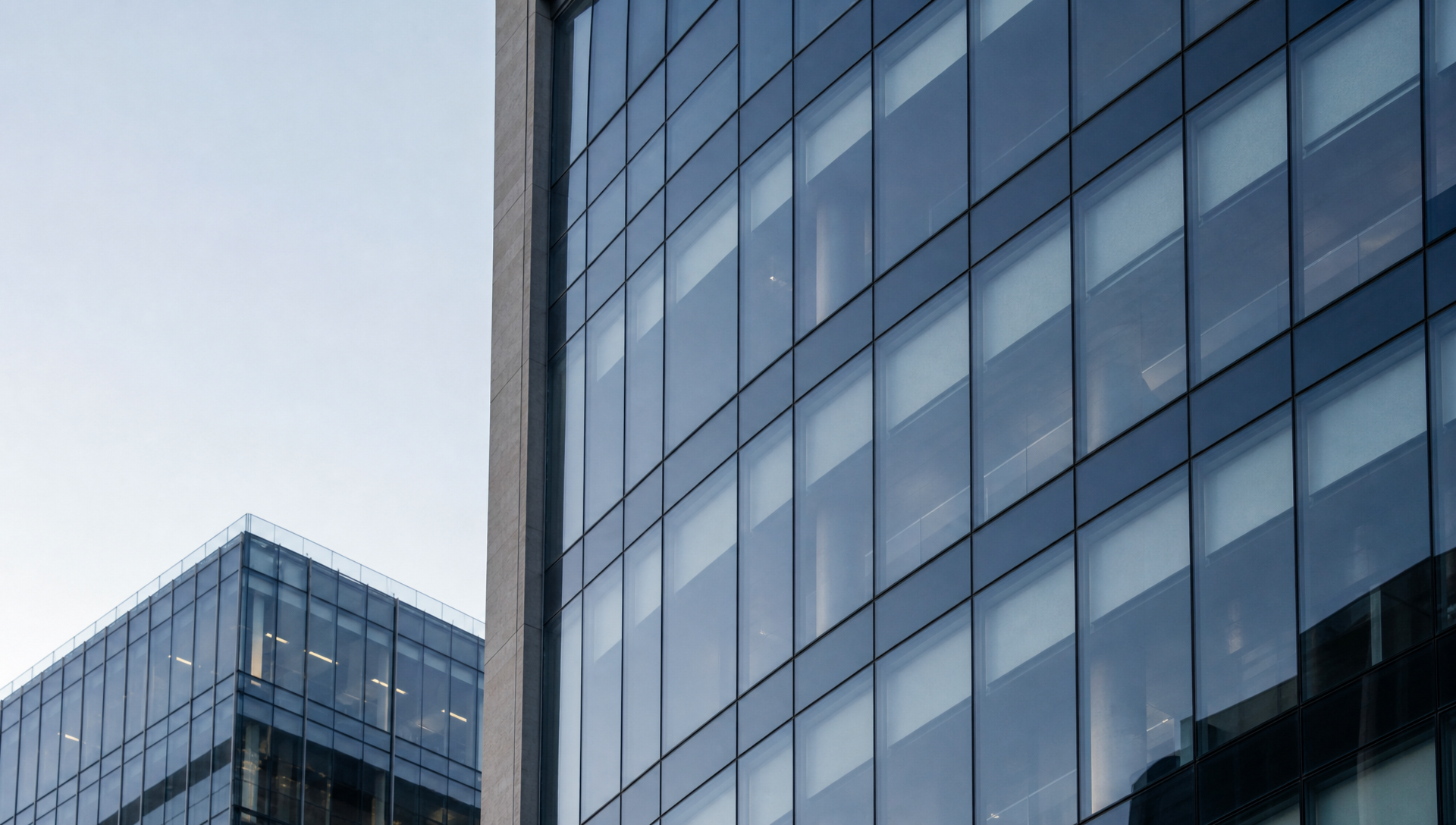 Modern glass corporate architecture with clean geometric lines and a restrained professional feel.